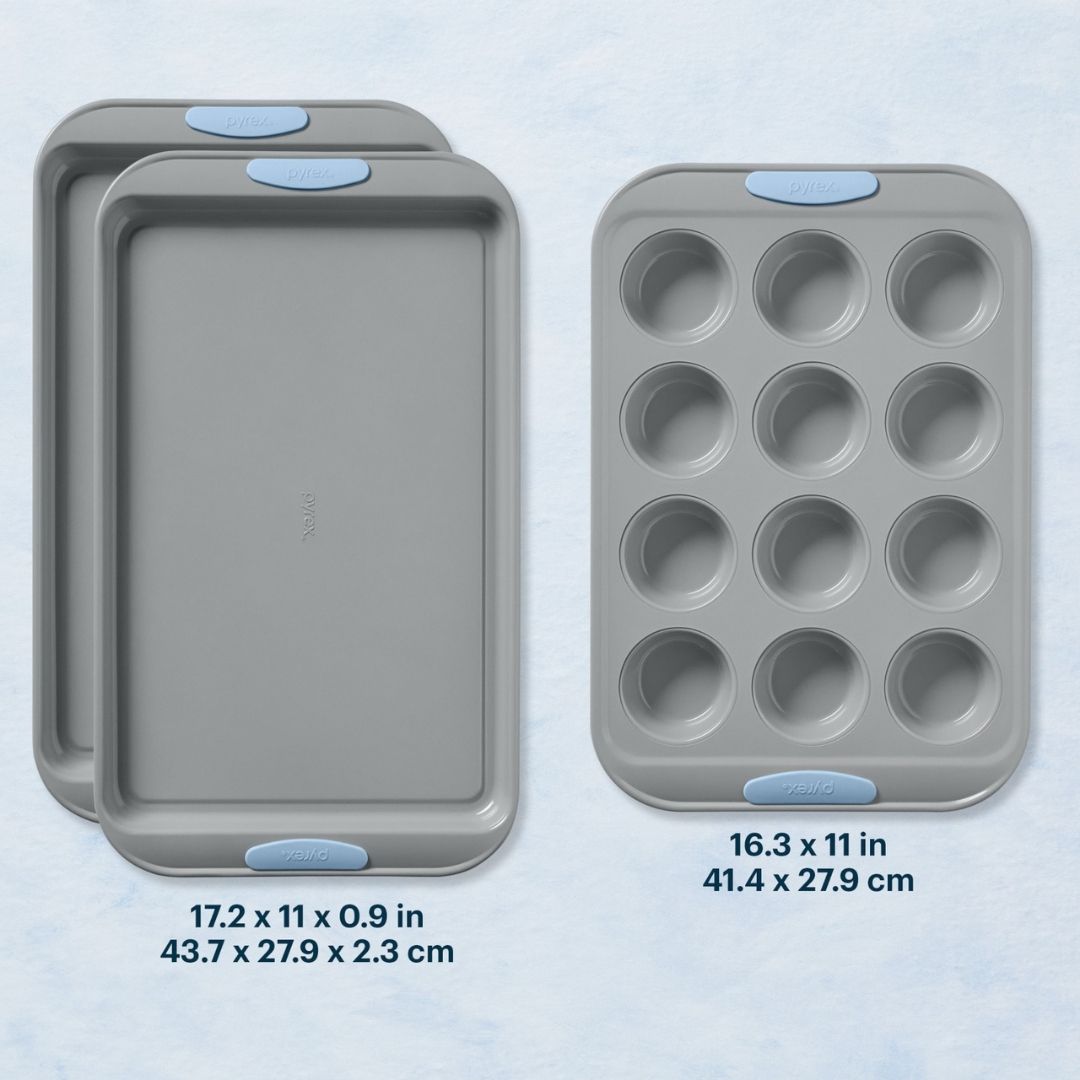 Set of three gray baking trays with blue silicone handles on a light blue background