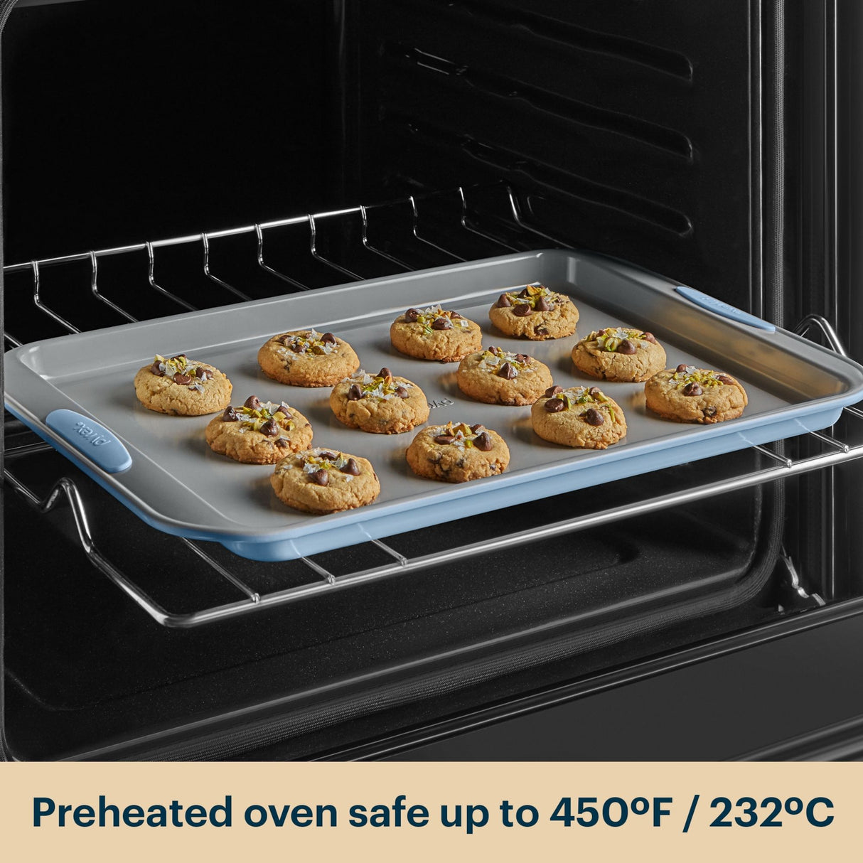 Cookies baking on a silicone baking mat in an oven with text indicating safe temperature.