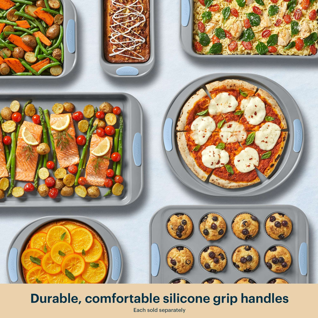 Collection of baked dishes with durable silicone grip handles on a light gray background.