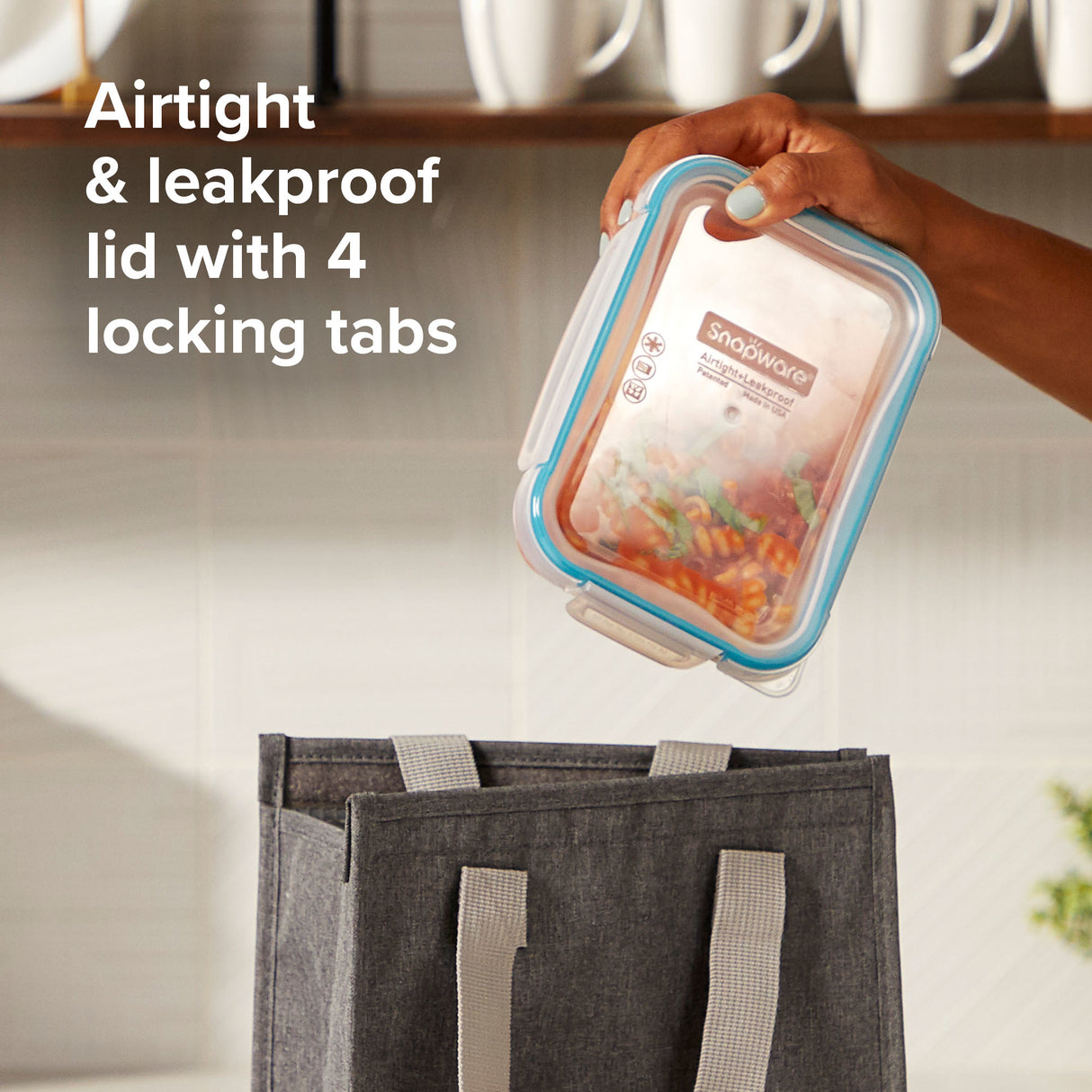 Kleanware container with airtight lid held over a tote bag in a kitchen setting